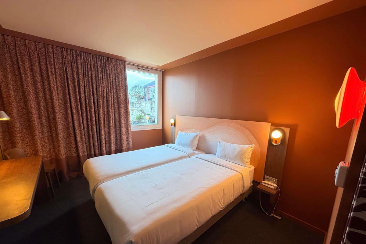 Premium bedding, desk, laptop workspace, blackout drapes