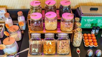 A variety of food items in jars, some with labels, and a tray with more jars.
