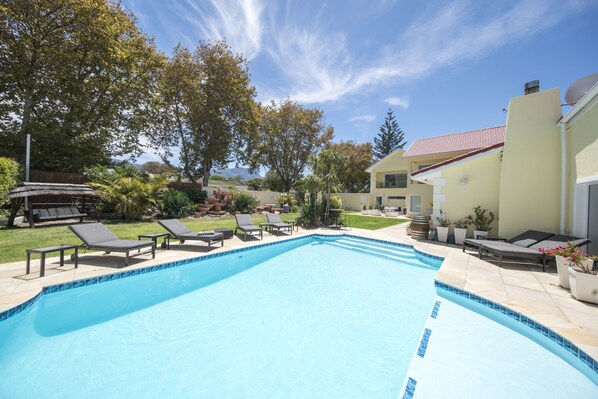 Seasonal outdoor pool, open 8:00 AM to 8:00 PM, pool umbrellas