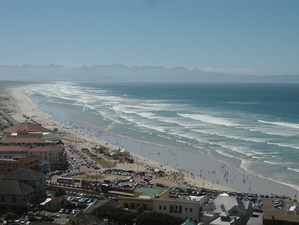 Beach nearby, white sand, beach umbrellas, beach towels