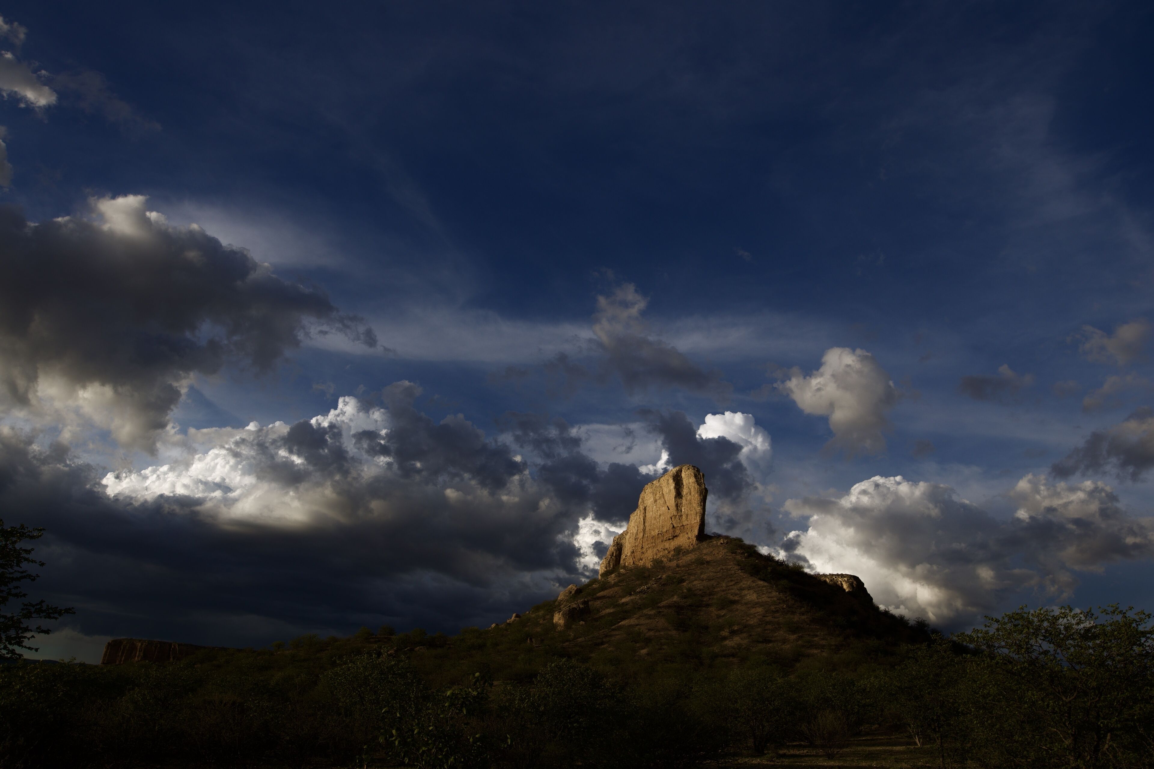 A rocky hill with a prominent rock formation.