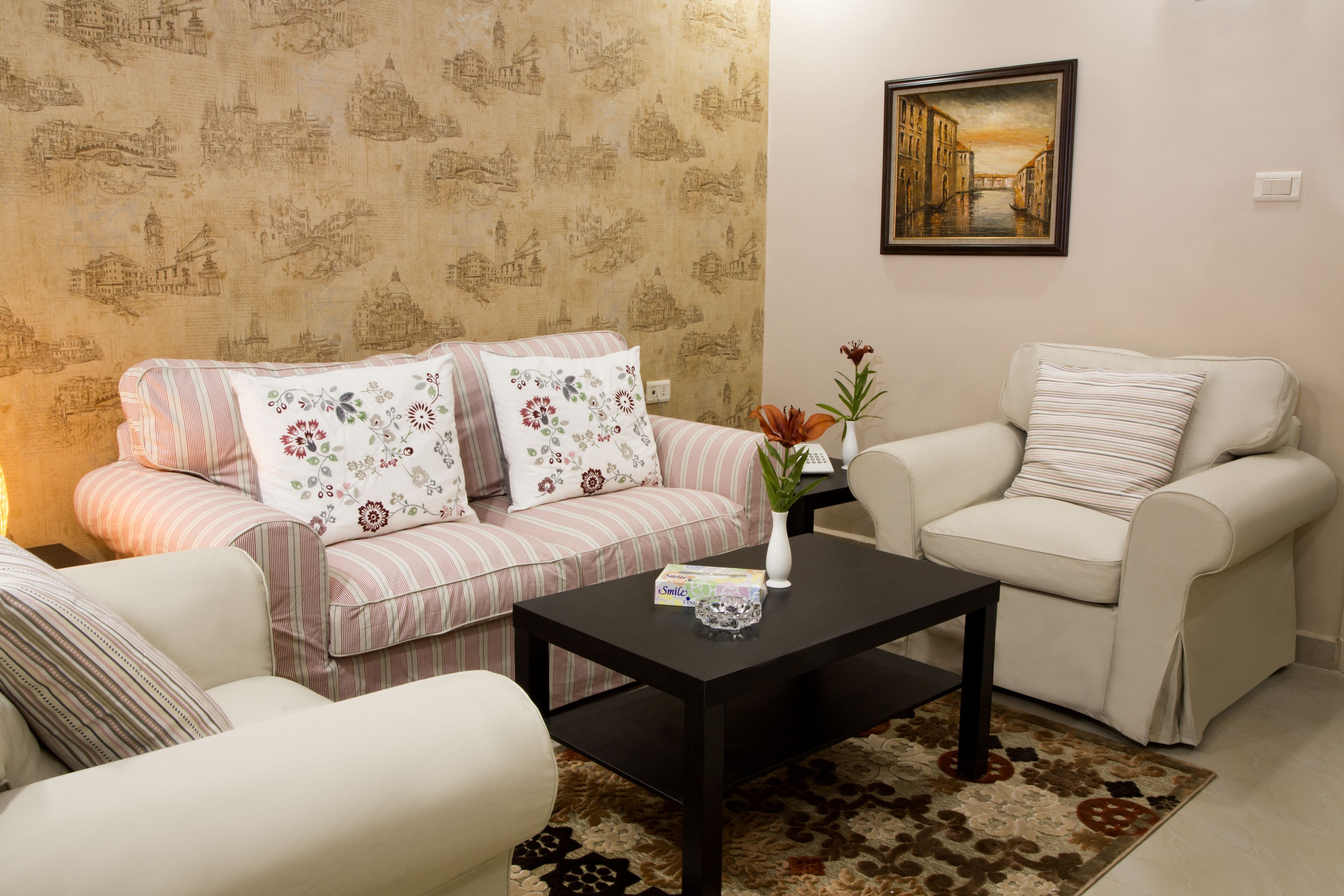 A living room with a sofa, armchair, and a coffee table.