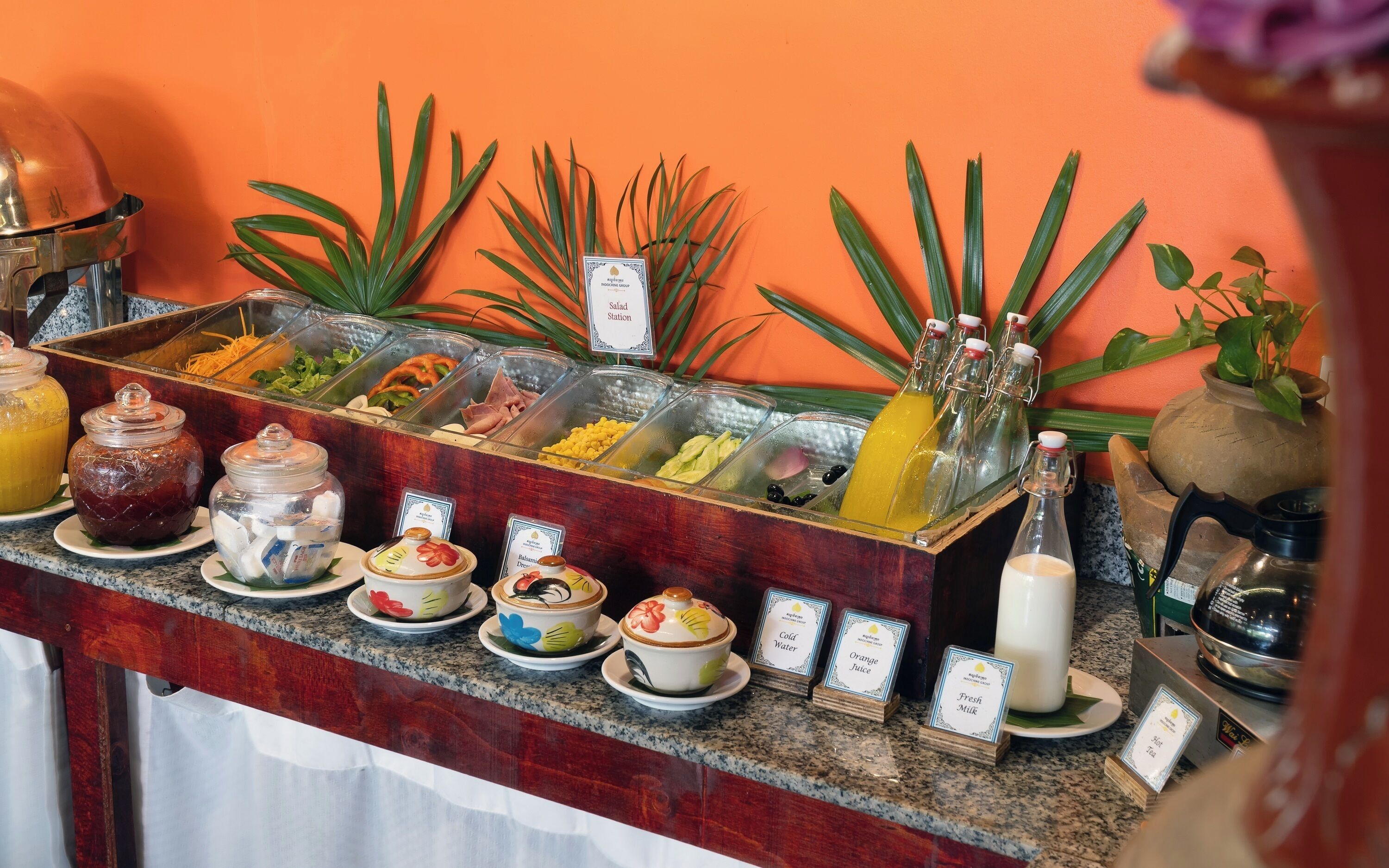 A buffet with various food options, a salad station, and a selection of beverages including milk and juice.
