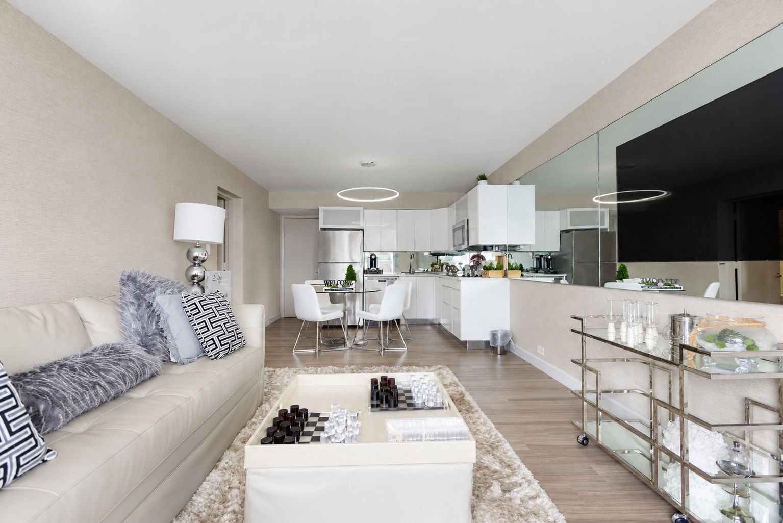 A modern apartment with a living room, kitchen, and dining area.