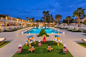 A pool area with lounge chairs and a large inflatable bear. - Magic Moment Resort & Kids Club, Dazzler Select by Wyndham (Kissimmee)
