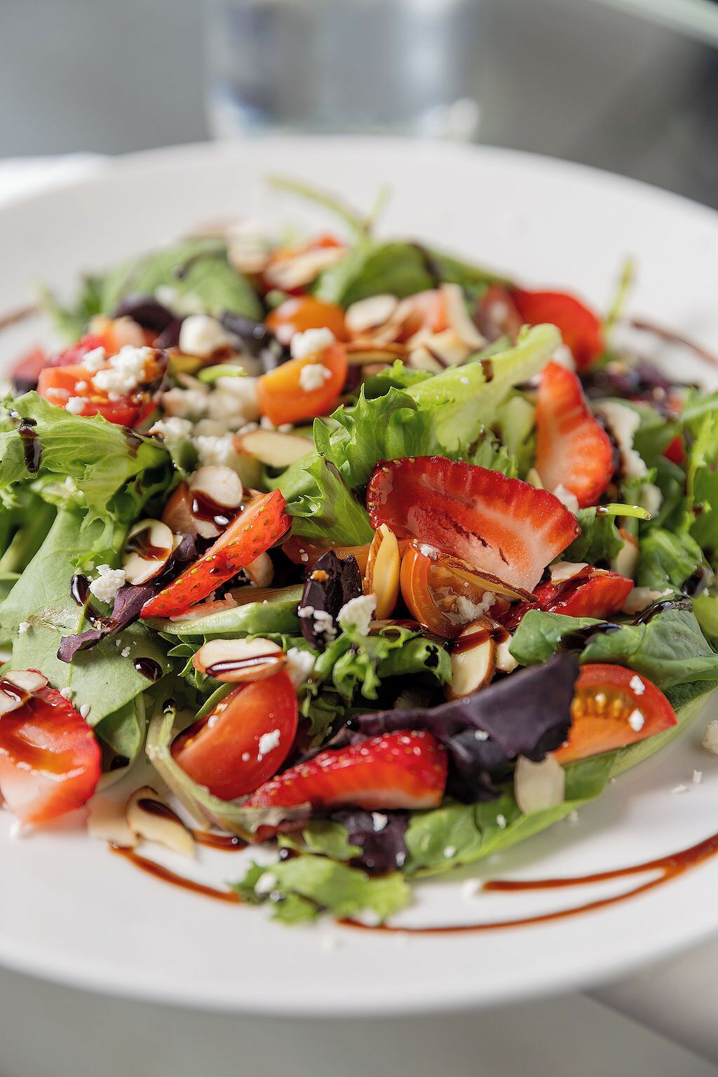 A salad with various ingredients on a white plate.