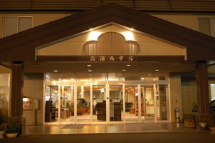 A hotel entrance with a sign reading "Northern Hotel" and a modern design with glass doors and a tiled roof.