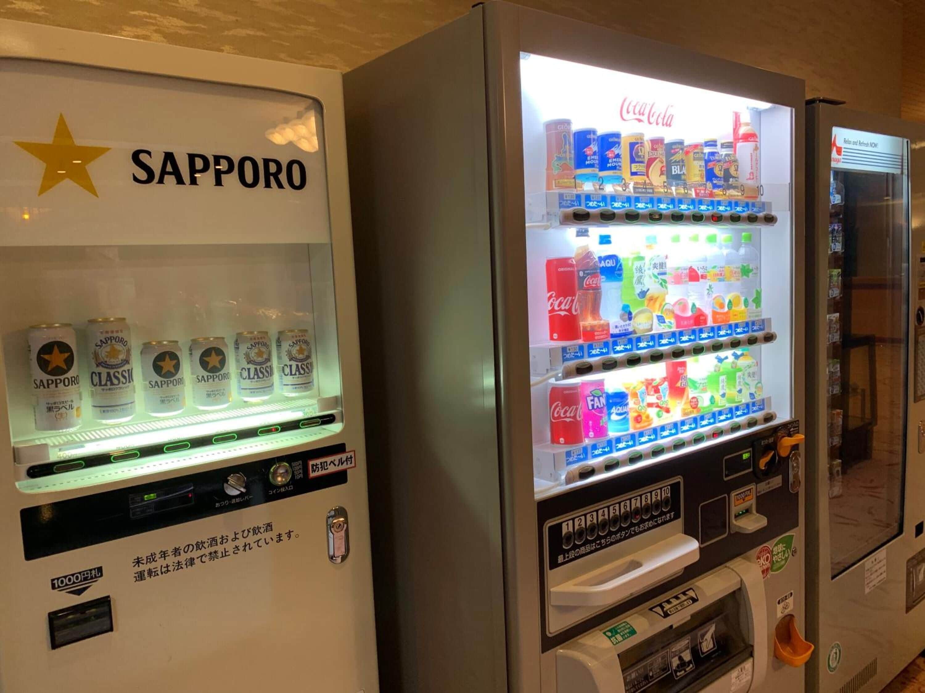 Vending machines with Sapporo beer and Coca-Cola.