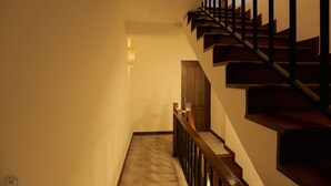 A staircase with wooden steps and black railings, leading to a door at the top. - Amaka Bed & Breakfast (Chiang Mai)