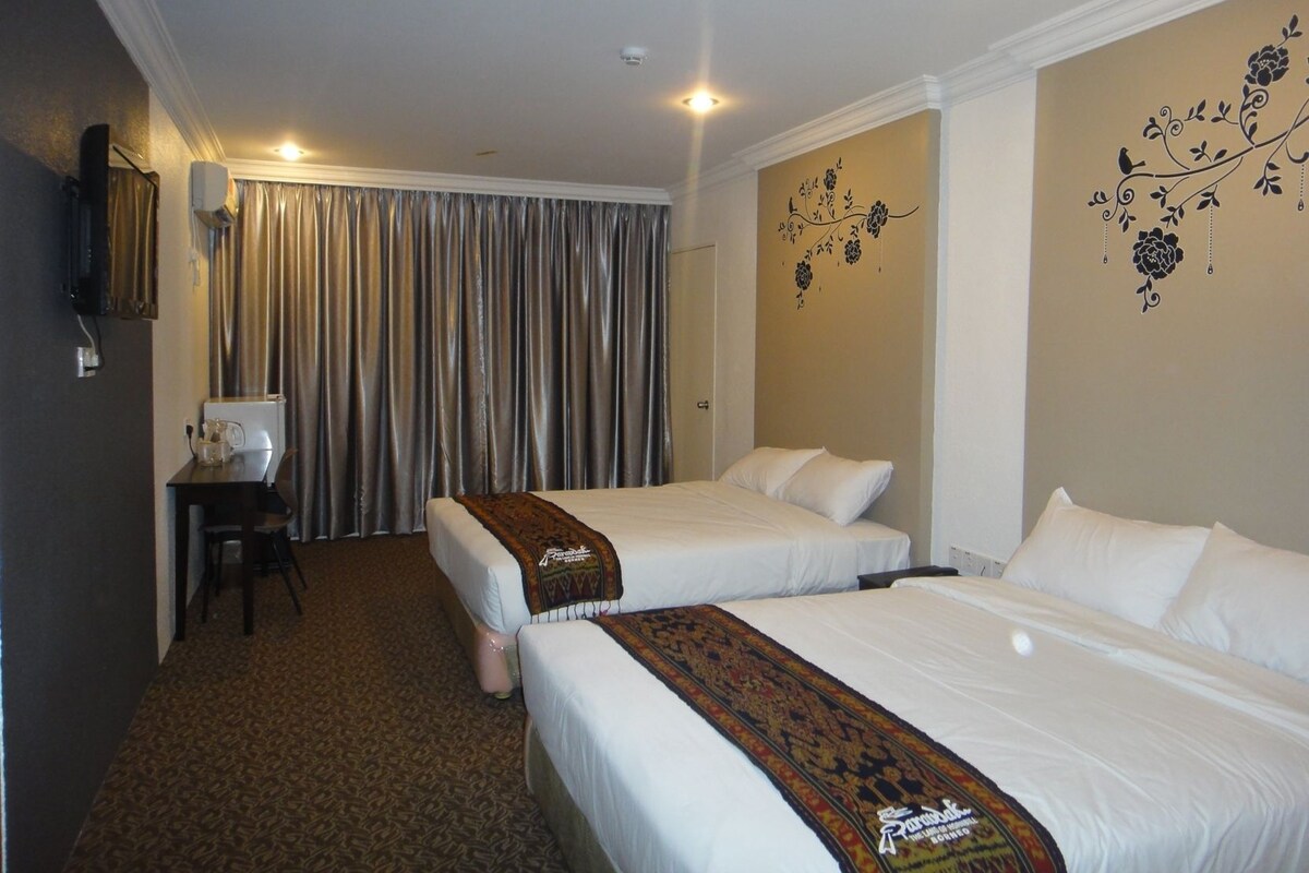 A hotel room with two beds, a desk, a chair, and a large window with curtains.