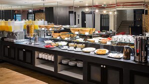 A buffet setup with various food items and beverages. - Sunshine Hip Hotel (Pattaya)