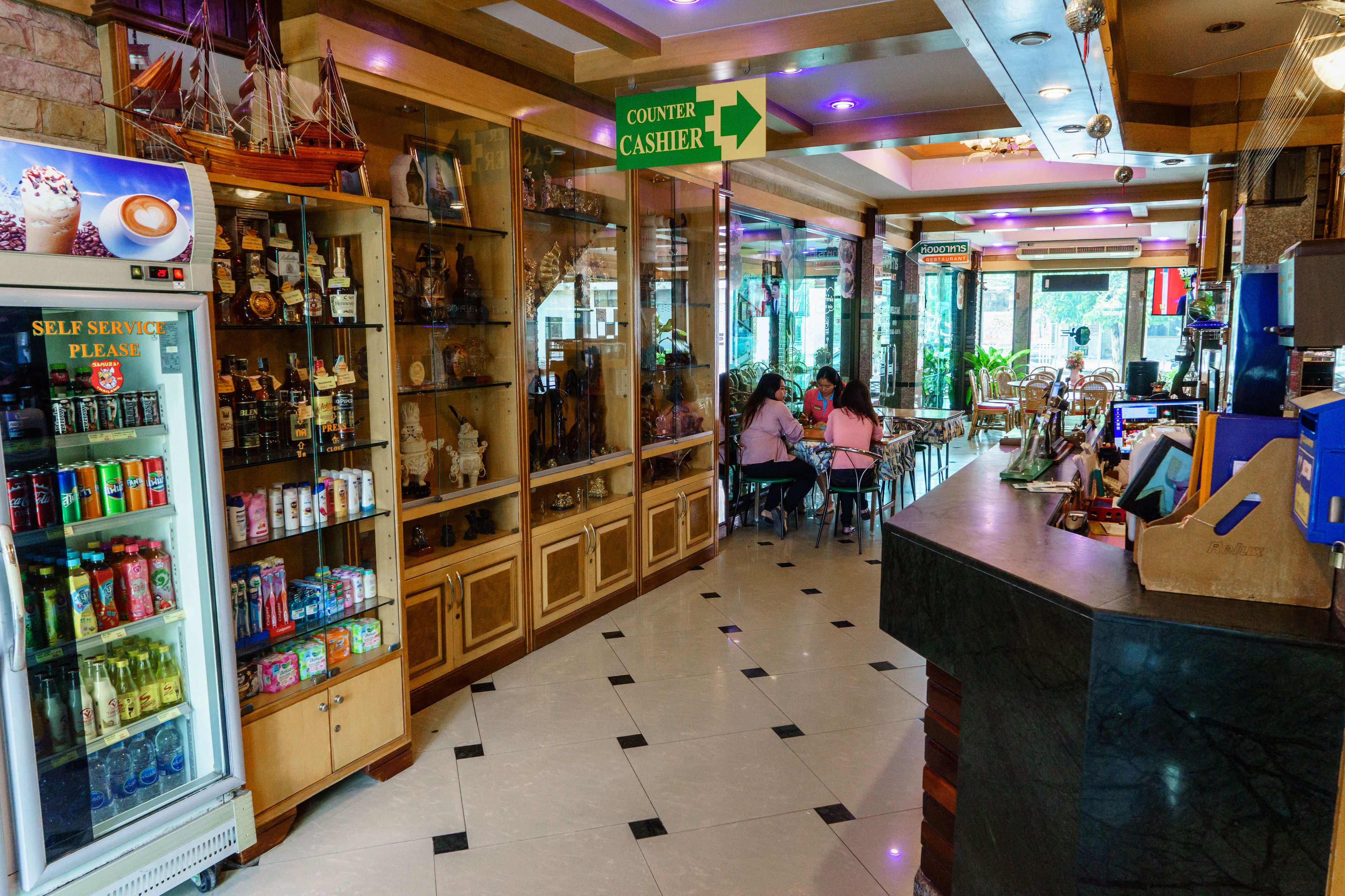 A self-service beverage area with a refrigerated display and shelves of snacks.