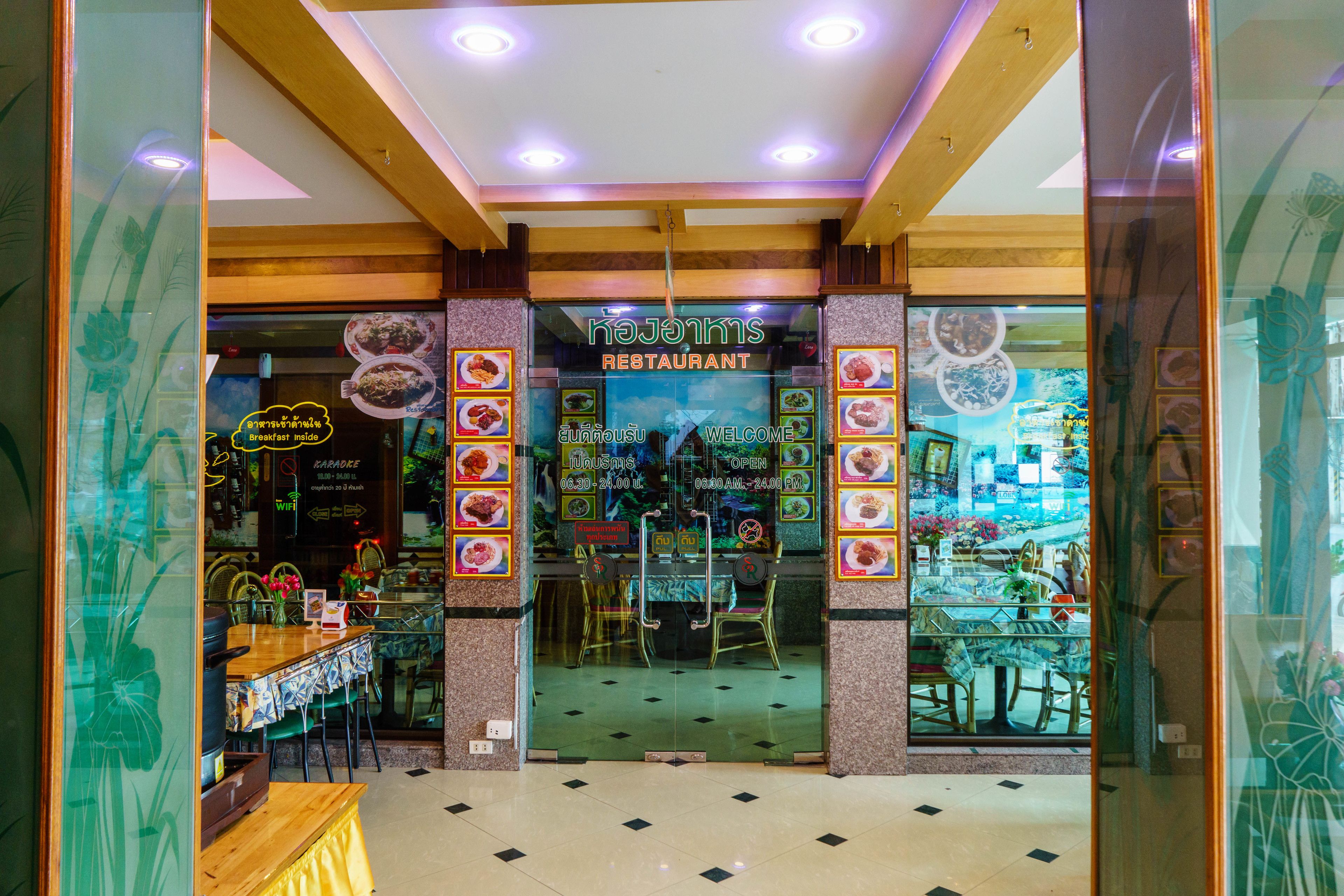 A restaurant with a glass entrance, wooden ceiling, and a sign that reads "kaJoints Restaurant".