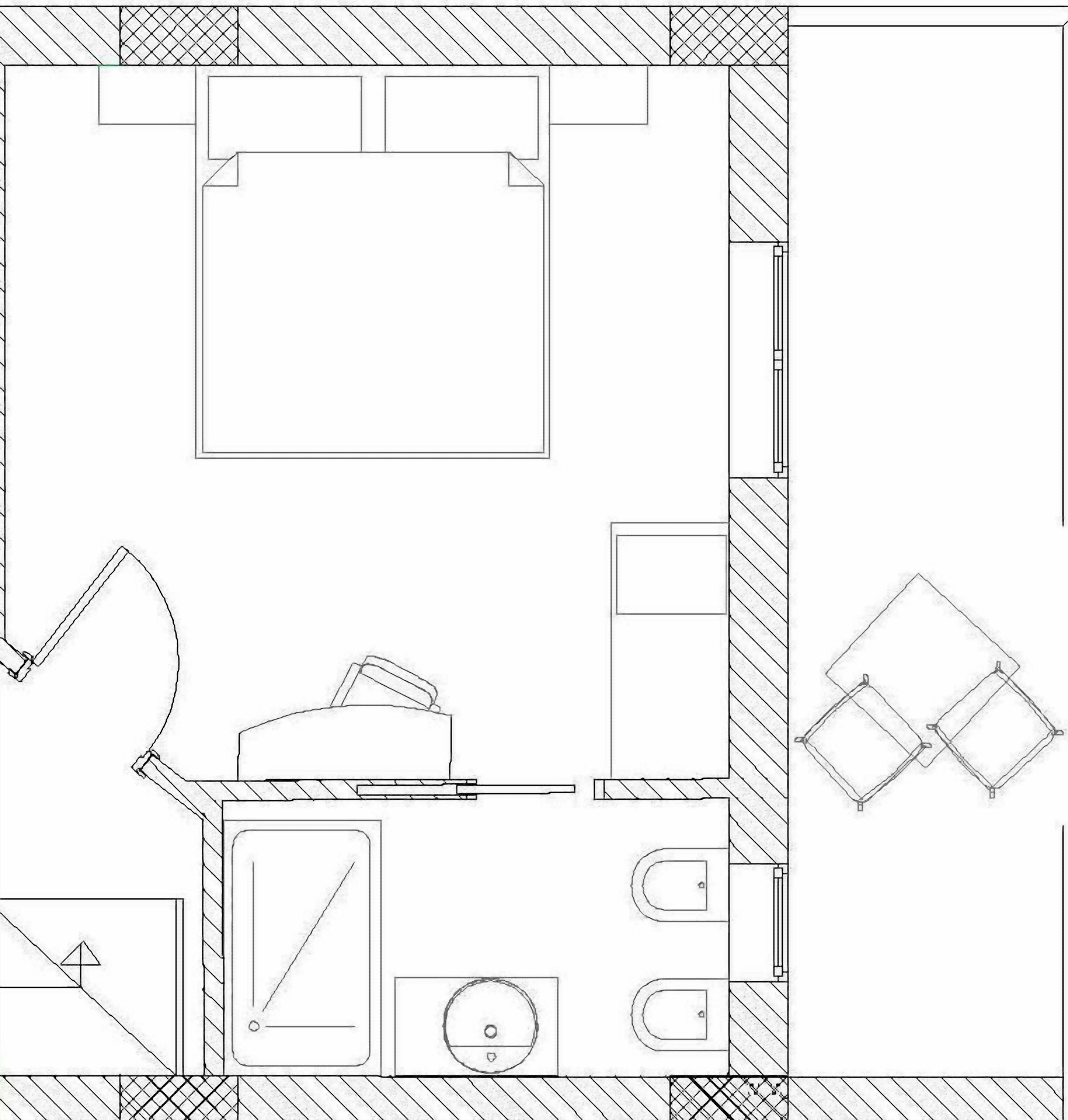 Plano de un cuarto de hotel que muestra una cama, un escritorio, una silla, un baño pequeño y un armario.