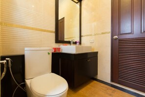 A bathroom with a toilet, sink, and mirror. - The Unique Krabi Private Pool Villa (Krabi)