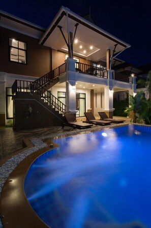 A two-story house with a swimming pool, outdoor seating, and a staircase leading to the upper level. - The Unique Krabi Private Pool Villa (Krabi)