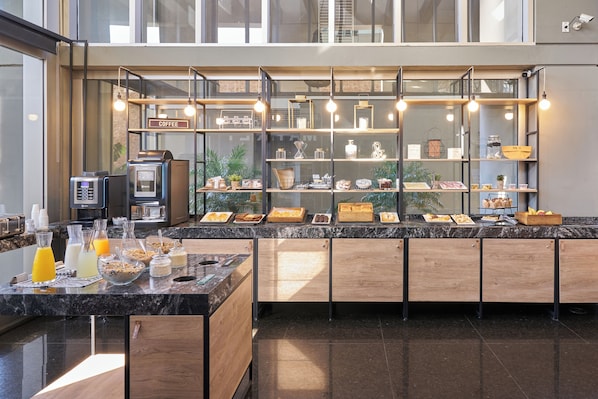A modern coffee bar with a marble countertop, glass display shelves, and a coffee machine.
