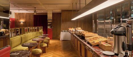 A hotel lobby with a seating area, a buffet, and a bar.