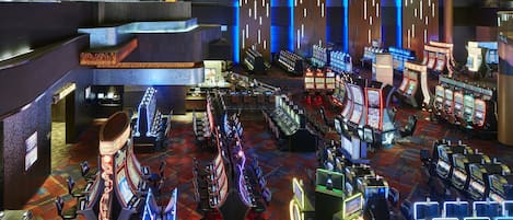 A casino with multiple gaming tables and slot machines.