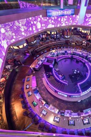 A circular bar area with multiple seating arrangements and a central DJ booth. - Harrah's Cherokee Casino Resort - A Caesars Rewards Destination (Cherokee)