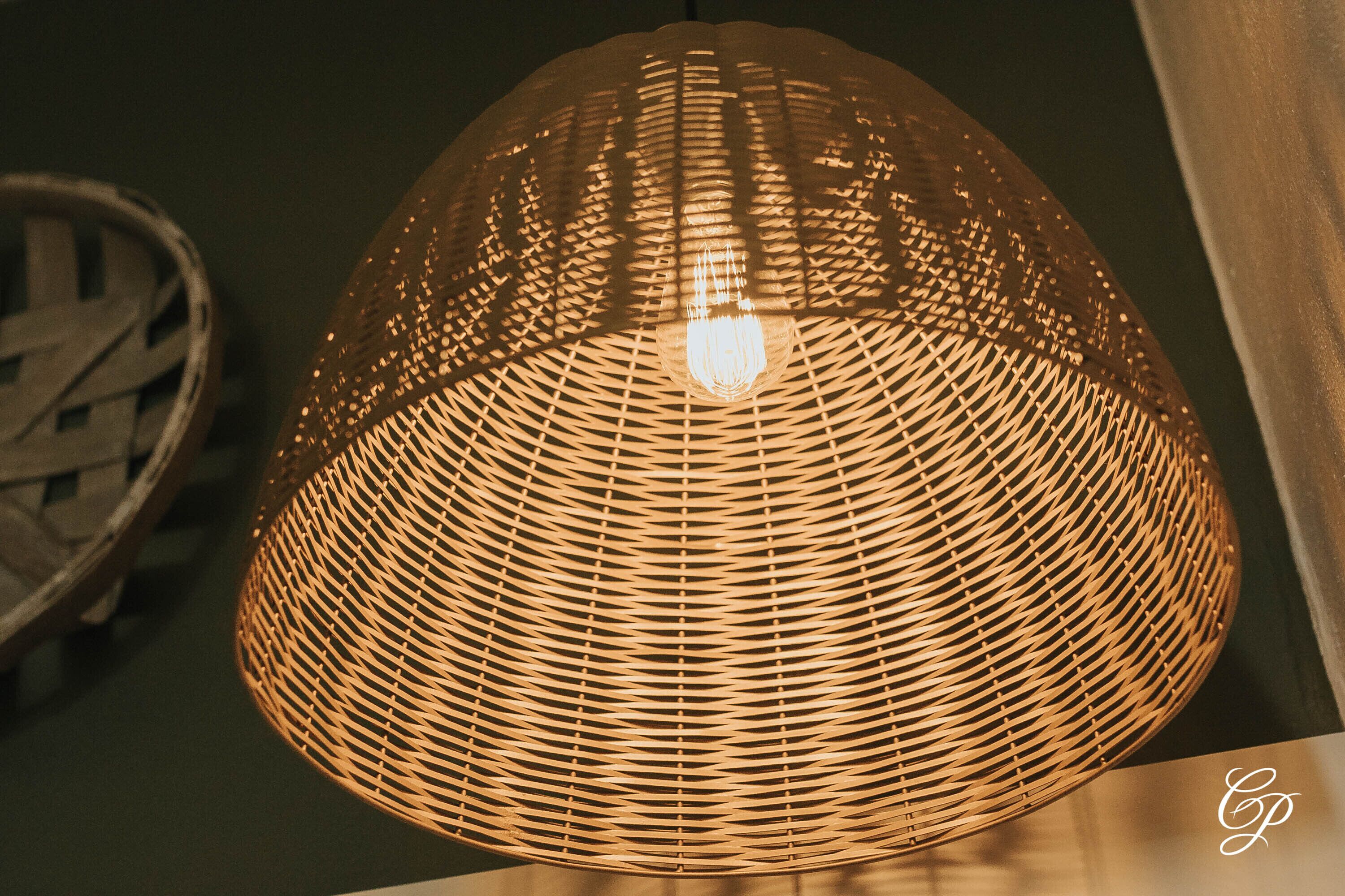 A woven, dome-shaped pendant light fixture.