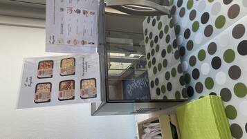 A food display with various dishes and a menu listing prices.