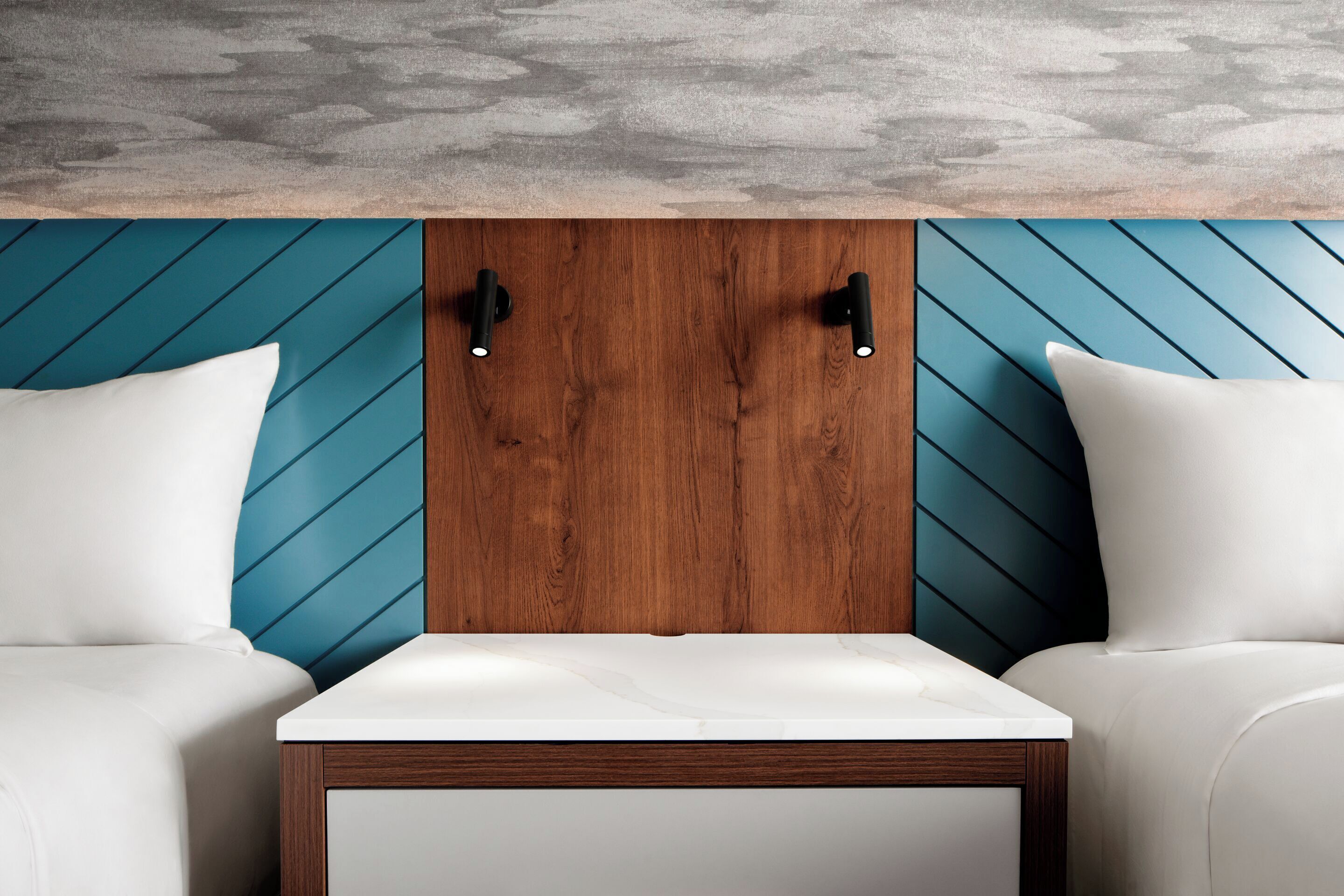 A modern room with a wooden headboard, two white pillows, and a white table.