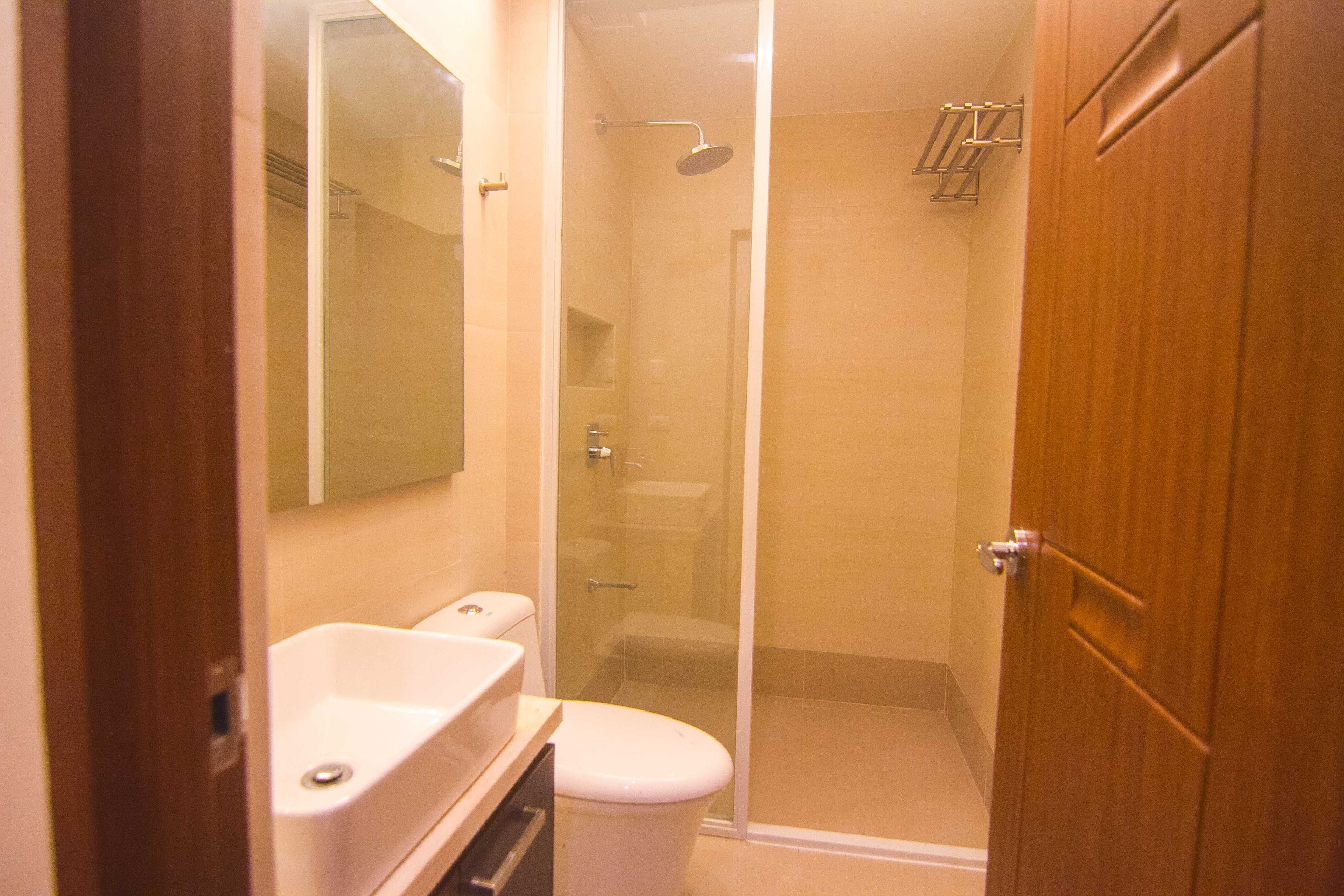 Ein Badezimmer mit Dusche, Toilette und Waschbecken.