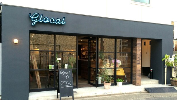 A storefront with a neon sign reading "Glocal Cafe" and a chalkboard sign outside stating "OPEN". - Glocal Nagoya Backpackers Hostel (Nagoya)