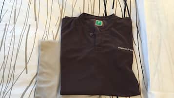 A neatly folded black shirt with a small logo on the chest and the text "Manten Hot" on the sleeve.