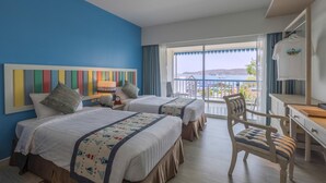 A hotel room with two beds, a desk, a chair, and a view of the sea. - Somewhere Koh Sichang (Ko Sichang)