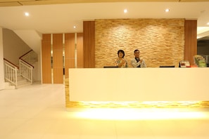A reception area with a wooden wall and a reception desk.