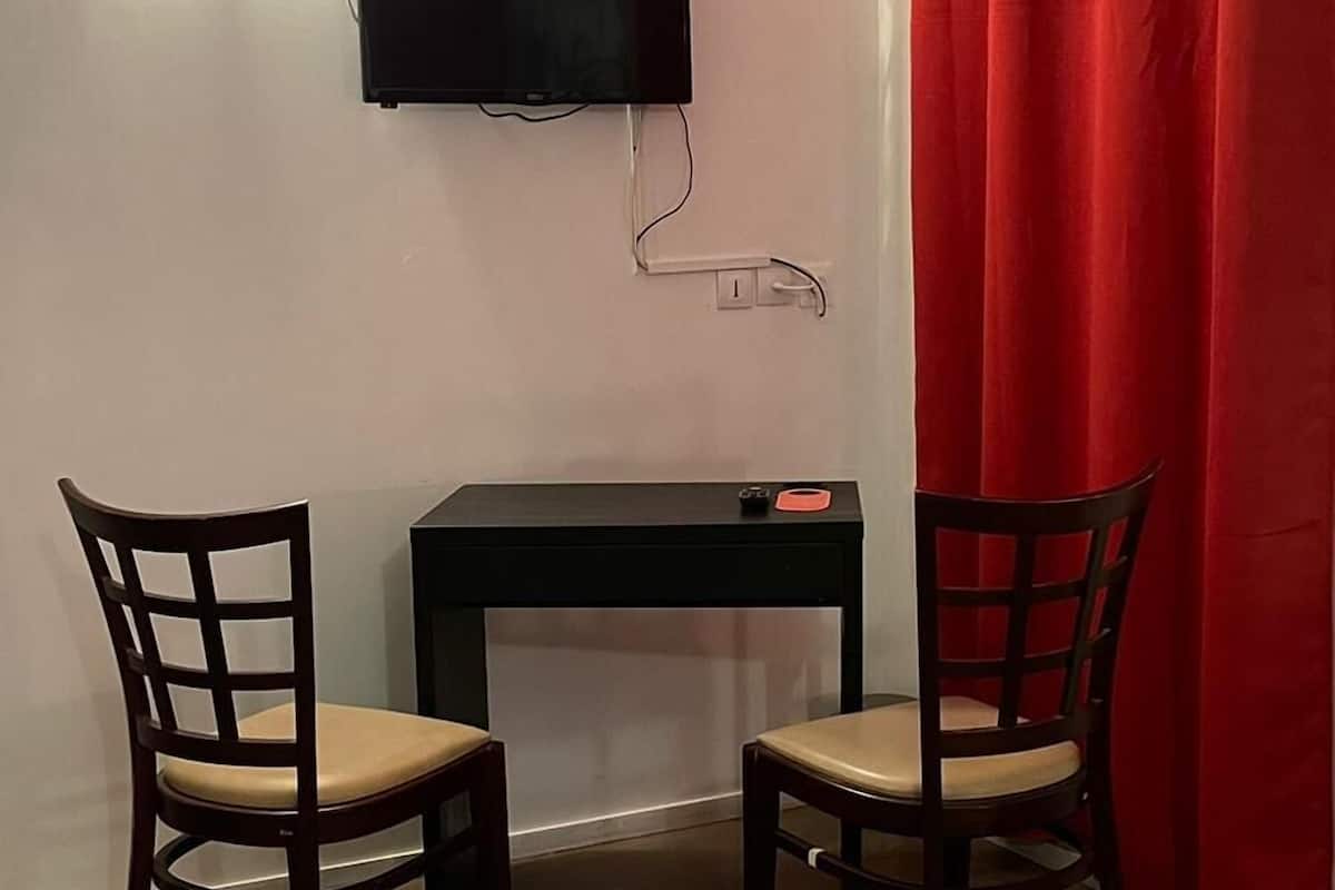 Basic Double Room, 1 Double Bed | Living area | 55-cm flat-screen TV with cable channels, TV