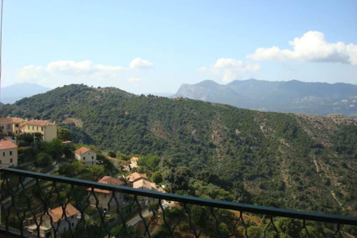 A mountainous landscape with a village and houses.