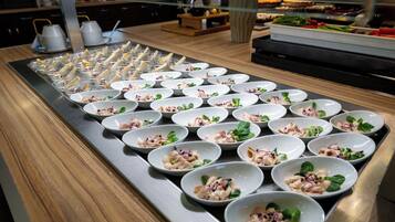 A buffet table with neatly arranged food bowls.
