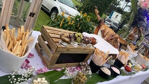 A buffet table with various food items and a wooden crate.