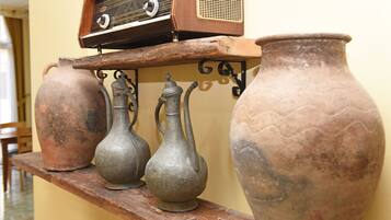 A shelf with three metal vases and a radio.