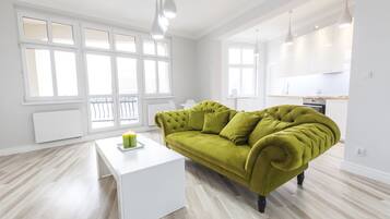 Premier Apartment, 1 Bedroom, City View | Living room | Flat-screen TV