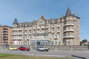 A large, historic building with multiple stories and a prominent corner turret. - The Grand Atlantic Hotel (Weston-super-Mare)