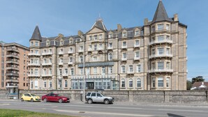 Un hotel grande e histórico, con varios pisos y una torre prominente en la esquina.