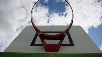 A basketball hoop with a clear sky in the background.