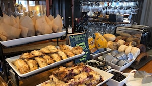 A buffet with various food items including pastries, muffins, and desserts. - 16 Bay View (Camden)