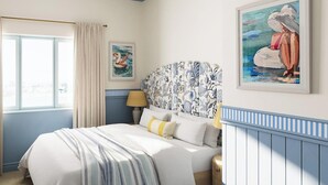 A bedroom with a bed, curtains, a lamp, a wall with a painting, and a window.