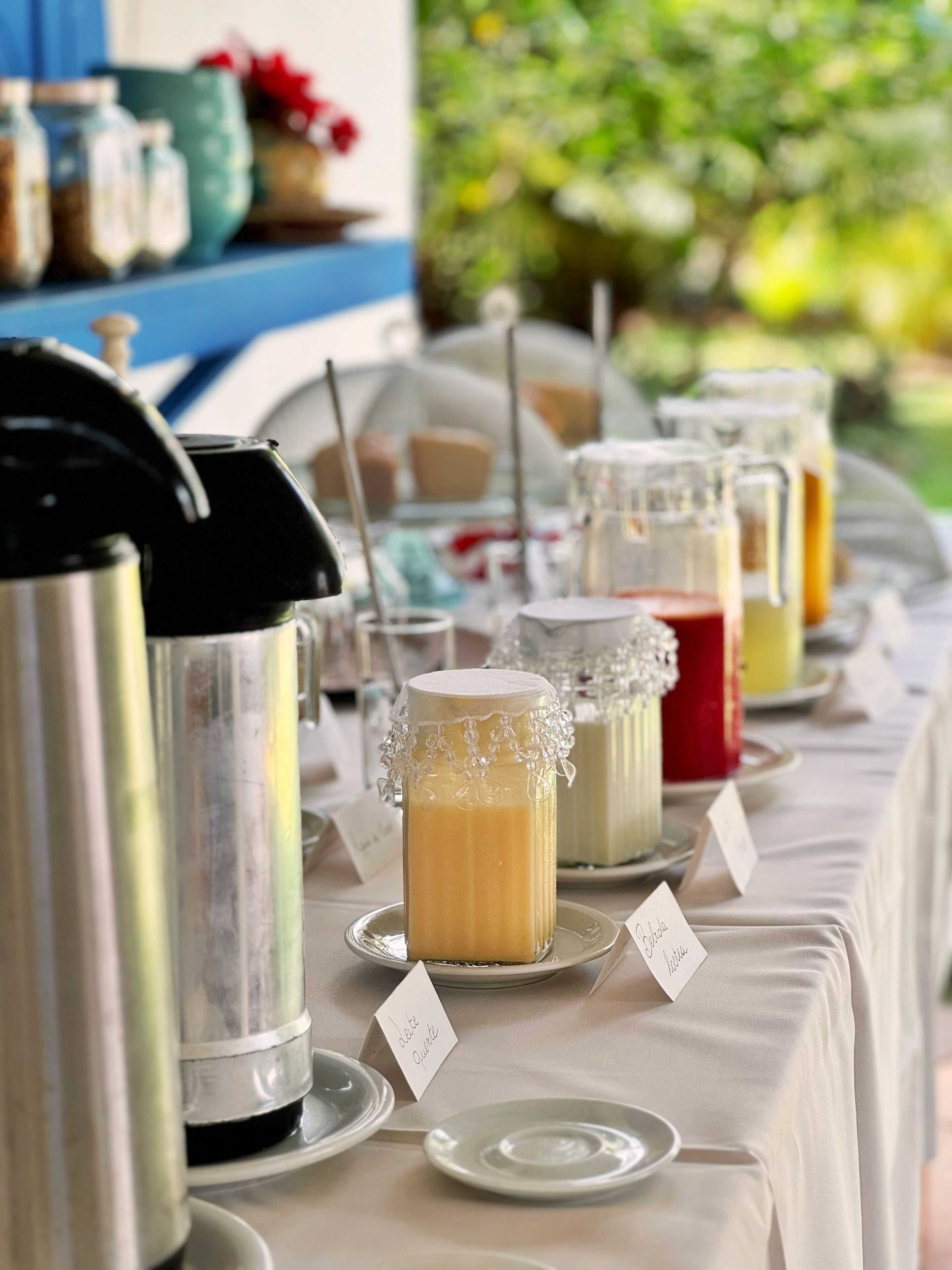 A buffet table with various food items and a coffee station.