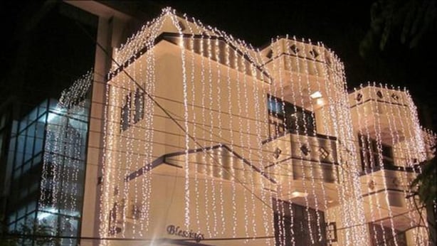 A building with multiple balconies and a series of lights hanging between the floors. - Blessings Jaipur (Jaipur)