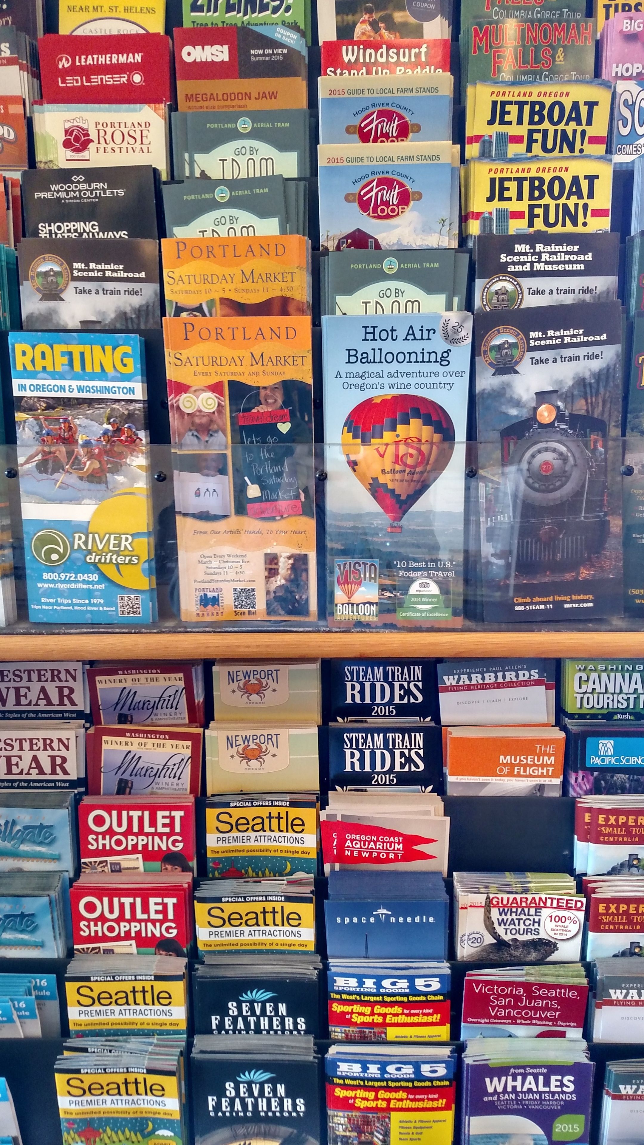A variety of travel guides and brochures for different destinations and activities.
