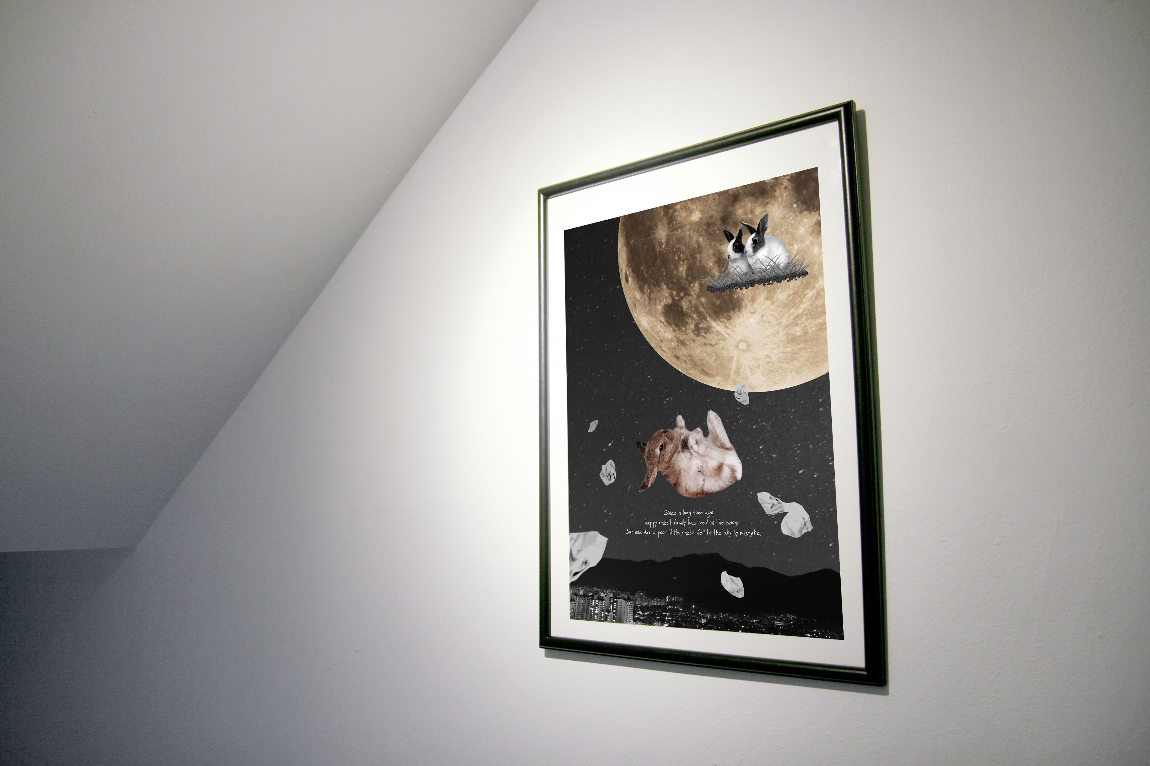 A framed artwork of a rabbit on a moon with a cityscape at the bottom.