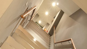 A staircase with wooden handrails and a modern design. - A Bizz (Lampang)