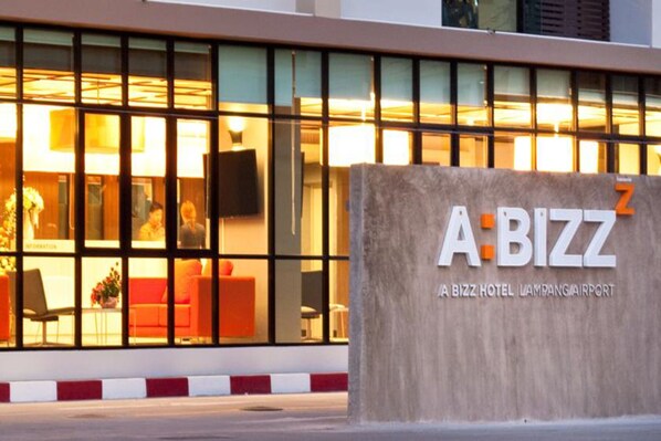 A hotel entrance with a large sign reading "A BIZZ HOTEL LAMPANG AIRPORT".