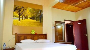 A bedroom with a wooden bed, a nightstand, a mirror, and a wardrobe.
